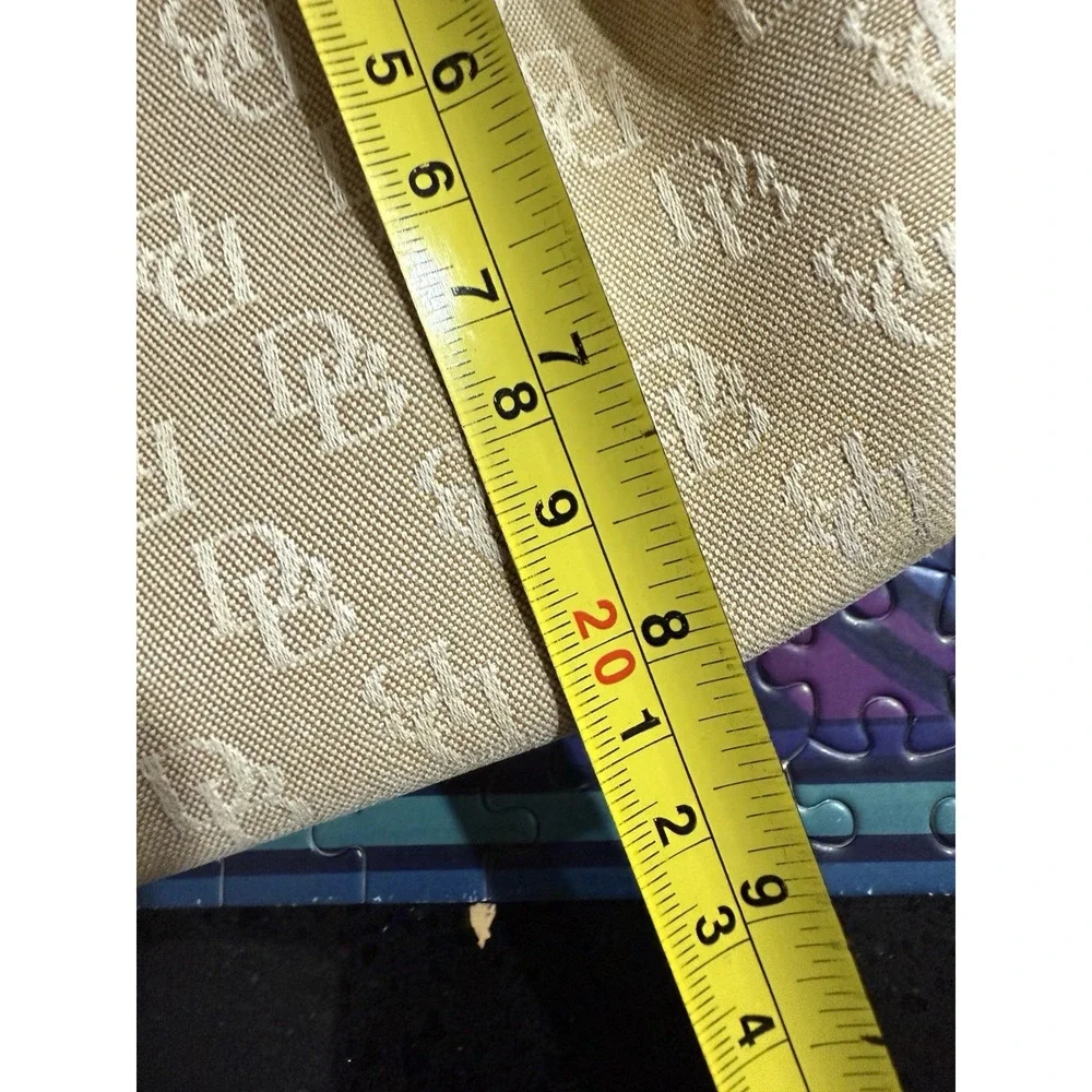 Dooney and Bourke Beige Canvas and Leather Signature Tassel Tote Handbag‎